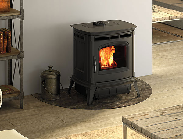 Traditional looking black Pellet Stove on dark marbled hearth pad in living room
