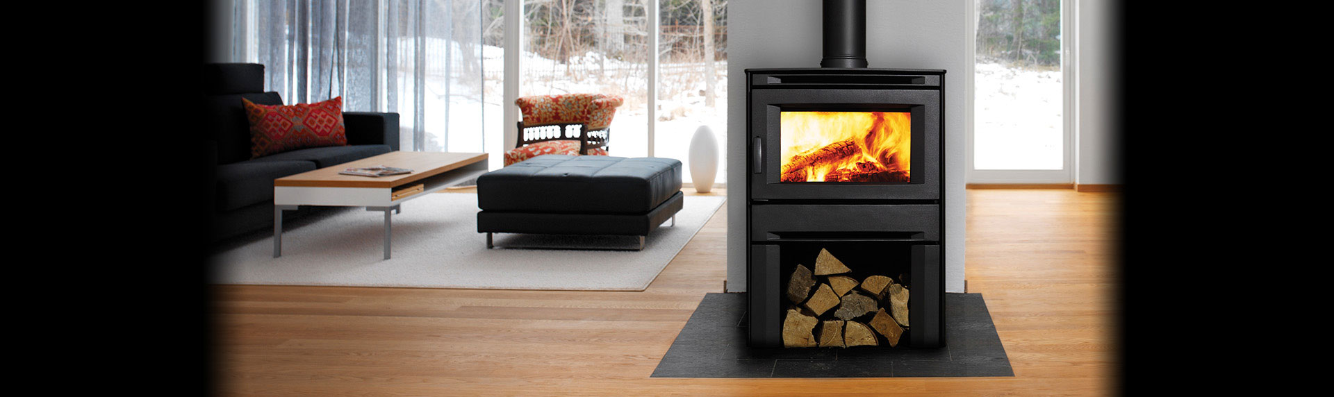 Modern Black Wood Stove with space for holding wood on black hearth pad